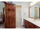 Bathroom featuring a wood door, glass shower, vanity, and bright lighting at 180 S 400 W, Lebanon, IN 46052