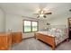 Bright bedroom with a large window, wooden furniture, and soft, neutral carpet at 180 S 400 W, Lebanon, IN 46052