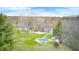 Expansive property with a covered pool, home with windmill, and ample greenery, offering a private retreat at 1907 N Washington St, Danville, IN 46122