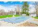 Exterior shot showcases a covered pool surrounded by a scenic yard and outbuildings at 1907 N Washington St, Danville, IN 46122