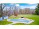 Lush backyard featuring a covered pool and storage shed surrounded by trees, providing a peaceful outdoor retreat at 1907 N Washington St, Danville, IN 46122