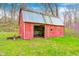 Rustic red barn with metal roof with weathered charm and a natural setting, blending rural aesthetics at 1907 N Washington St, Danville, IN 46122