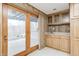 Finished basement featuring a wet bar, tile flooring, and access to the outdoors at 1907 N Washington St, Danville, IN 46122