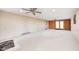 Large finished basement with modern ceiling fans, tile floors, and carpet at 1907 N Washington St, Danville, IN 46122