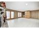 Basement featuring tile floors, a brick fireplace, cabinets, and outdoor access at 1907 N Washington St, Danville, IN 46122