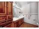 A full bathroom featuring wood cabinets, a white countertop, and wood-style floors at 1907 N Washington St, Danville, IN 46122