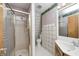 Tiled bathroom showcasing a glass-doored shower, toilet, and single-sink vanity at 1907 N Washington St, Danville, IN 46122