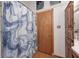 Bathroom with a shower showcasing a blue shower curtain, and storage cabinets at 1907 N Washington St, Danville, IN 46122