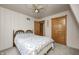 Cozy bedroom featuring wood closet doors, ceiling fan, and classic striped wallpaper at 1907 N Washington St, Danville, IN 46122