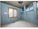 Bedroom with blue wood walls, carpeted floors, and a window with a view at 1907 N Washington St, Danville, IN 46122