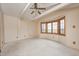 Bright bedroom showcasing a ceiling fan and window at 1907 N Washington St, Danville, IN 46122