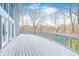 Spacious outdoor deck with a vibrant sunburst pattern and a view of the surrounding trees at 1907 N Washington St, Danville, IN 46122