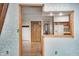 A naturally lit entryway with detailed wood frames and a view to the kitchen, hardwood floors, and flower detailed wood door at 1907 N Washington St, Danville, IN 46122
