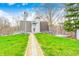 Unique home with a charming windmill feature, complemented by a stone pathway and well-maintained lawn at 1907 N Washington St, Danville, IN 46122