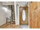 Foyer with a decorative wood door, hardwood floors, and a unique spiral staircase at 1907 N Washington St, Danville, IN 46122