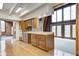 Open kitchen with wood cabinets, a large island, and access to a large living space at 1907 N Washington St, Danville, IN 46122