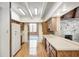 A bright kitchen with wood cabinets and countertops and views to the sun room at 1907 N Washington St, Danville, IN 46122
