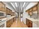 Spacious kitchen with wood cabinets and trim with view to spiral staircase and sun room at 1907 N Washington St, Danville, IN 46122
