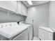 Efficient laundry room with white washer, dryer, and ample storage cabinets at 1907 N Washington St, Danville, IN 46122