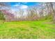 Expansive lawn surrounded by trees with blossoming trees providing a serene, picturesque outdoor space at 1907 N Washington St, Danville, IN 46122
