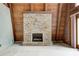 Cozy living room featuring a stone fireplace and wood-paneled walls for a rustic ambiance at 1907 N Washington St, Danville, IN 46122