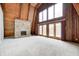 Spacious living room with a stone fireplace, wood accents, and natural light at 1907 N Washington St, Danville, IN 46122