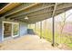 Covered patio with serene views, offering an inviting space for relaxing and enjoying nature near the back of home at 1907 N Washington St, Danville, IN 46122