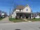 Charming two-story home featuring a cozy front porch and well-maintained front yard at 210 E Monroe St, Alexandria, IN 46001