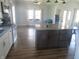 Bright, open kitchen and living room with stainless steel appliances, granite countertops, and hardwood floors at 210 E Monroe St, Alexandria, IN 46001