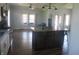 Open-concept kitchen featuring stainless steel appliances, hardwood floors, and an island with seating at 210 E Monroe St, Alexandria, IN 46001