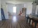 Open-concept living room featuring hardwood floors, modern light fixtures and staircase access at 210 E Monroe St, Alexandria, IN 46001