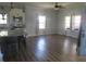 Well-lit kitchen and living room featuring stainless steel appliances, hardwood floors, and three windows at 210 E Monroe St, Alexandria, IN 46001