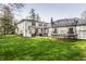 Expansive backyard with a well-manicured lawn, featuring a trampoline and access to the patio area at 222 E 71St St, Indianapolis, IN 46220
