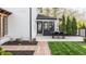 Well-manicured backyard featuring a brick patio with outdoor seating, lush green lawn, and elegant landscaping at 222 E 71St St, Indianapolis, IN 46220