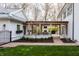Charming backyard with a brick pathway leading to an open patio, featuring lush green grass and mature trees at 222 E 71St St, Indianapolis, IN 46220
