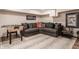 Basement area featuring a cozy gray sectional sofa with colorful throw pillows and a foosball table at 222 E 71St St, Indianapolis, IN 46220