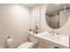 Bathroom featuring a stylish white sink and a decorative mirror with a view of a glass-door shower at 222 E 71St St, Indianapolis, IN 46220