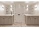 Bright bathroom with double vanity, stone counters, and herringbone floors at 222 E 71St St, Indianapolis, IN 46220