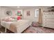 Cozy bedroom featuring a white frame bed with plush pillows, a decorative mirror, and a colorful area rug at 222 E 71St St, Indianapolis, IN 46220