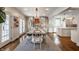 Well-lit dining room with a modern chandelier, an elegant table, and backyard access at 222 E 71St St, Indianapolis, IN 46220
