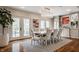 Elegant dining room with modern lighting, a table for eight, and access to the yard at 222 E 71St St, Indianapolis, IN 46220