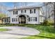 Traditional two-story home with a circular driveway and a well-maintained lawn at 222 E 71St St, Indianapolis, IN 46220