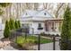 Charming home with a fenced yard, a modern garage, and inviting walkway, enhancing curb appeal at 222 E 71St St, Indianapolis, IN 46220