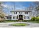 Charming white brick home with a circular driveway and manicured lawn at 222 E 71St St, Indianapolis, IN 46220