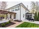 An inviting backyard featuring a brick patio, pergola, and well-manicured lawn of this updated home at 222 E 71St St, Indianapolis, IN 46220