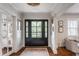 Inviting foyer with a black front door, hardwood floors, and stylish decor at 222 E 71St St, Indianapolis, IN 46220