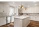 Updated kitchen features an island, stainless steel appliances, and white cabinets at 222 E 71St St, Indianapolis, IN 46220