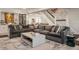 Spacious living room with a large sectional sofa, decor, and staircase at 222 E 71St St, Indianapolis, IN 46220