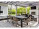 Relaxing outdoor patio with a wooden pergola, comfortable seating, outdoor fireplace, and lush greenery at 222 E 71St St, Indianapolis, IN 46220
