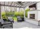 Inviting outdoor living space featuring a fireplace, television, and comfortable seating under a pergola at 222 E 71St St, Indianapolis, IN 46220